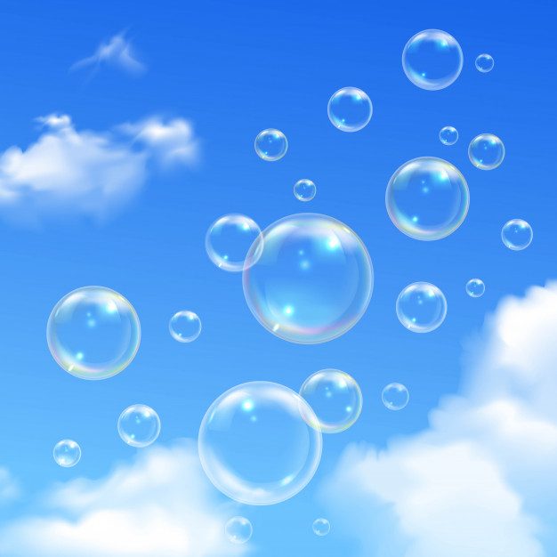 Soap bubbles floating against a blue sky